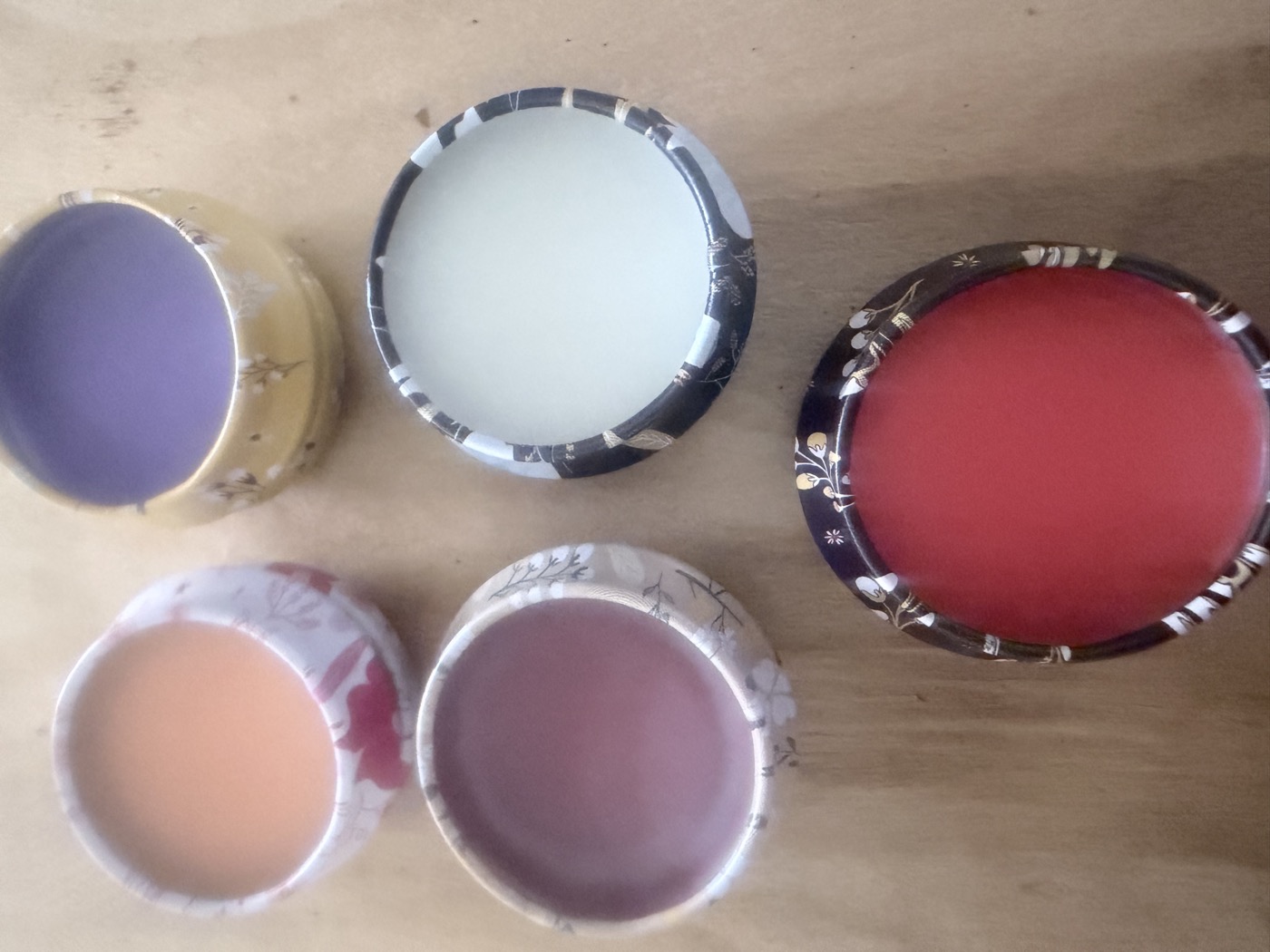 Colorful handmade lip balm pots viewed from above