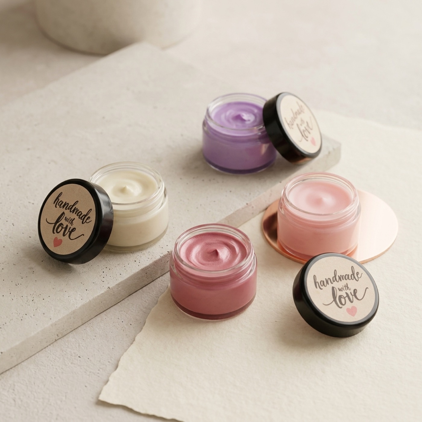 Mia Luxe balm pots in soft pink, lavender, and cream tones
