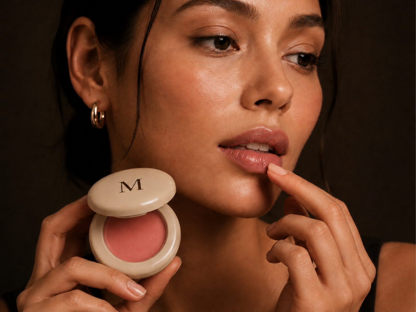 Woman applying MiaLuxe lip balm while holding the open compact